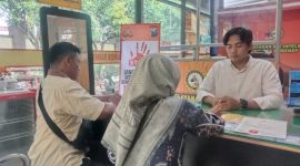 Foto : BRIPDA KRISNADI (Kemeja putih) saat melayani pembuatan SKCK kepada masyarakat. 