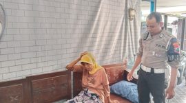 Foto: Bripka Muhammad Luthfi, anggota Tim Elang Satlantas Polres Sumenep, saat mengevakuasi warga yang pingsan di perempatan Jl. Trunojoyo, Rabu (16/4/2025) pagi. 