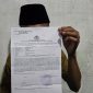 Foto: Seorang mahasiswa UIN Madura menunjukkan bukti laporan polisi atas kasus pemukulan yang dialaminya, Rabu malam (4/6/2025).
